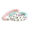 Itzy Ritzy Teething Rings - Set of 3 Textured, Silicone Rings for Ages 3 Months & Up - One-Piece Design with Adorable Messages (Pastel)