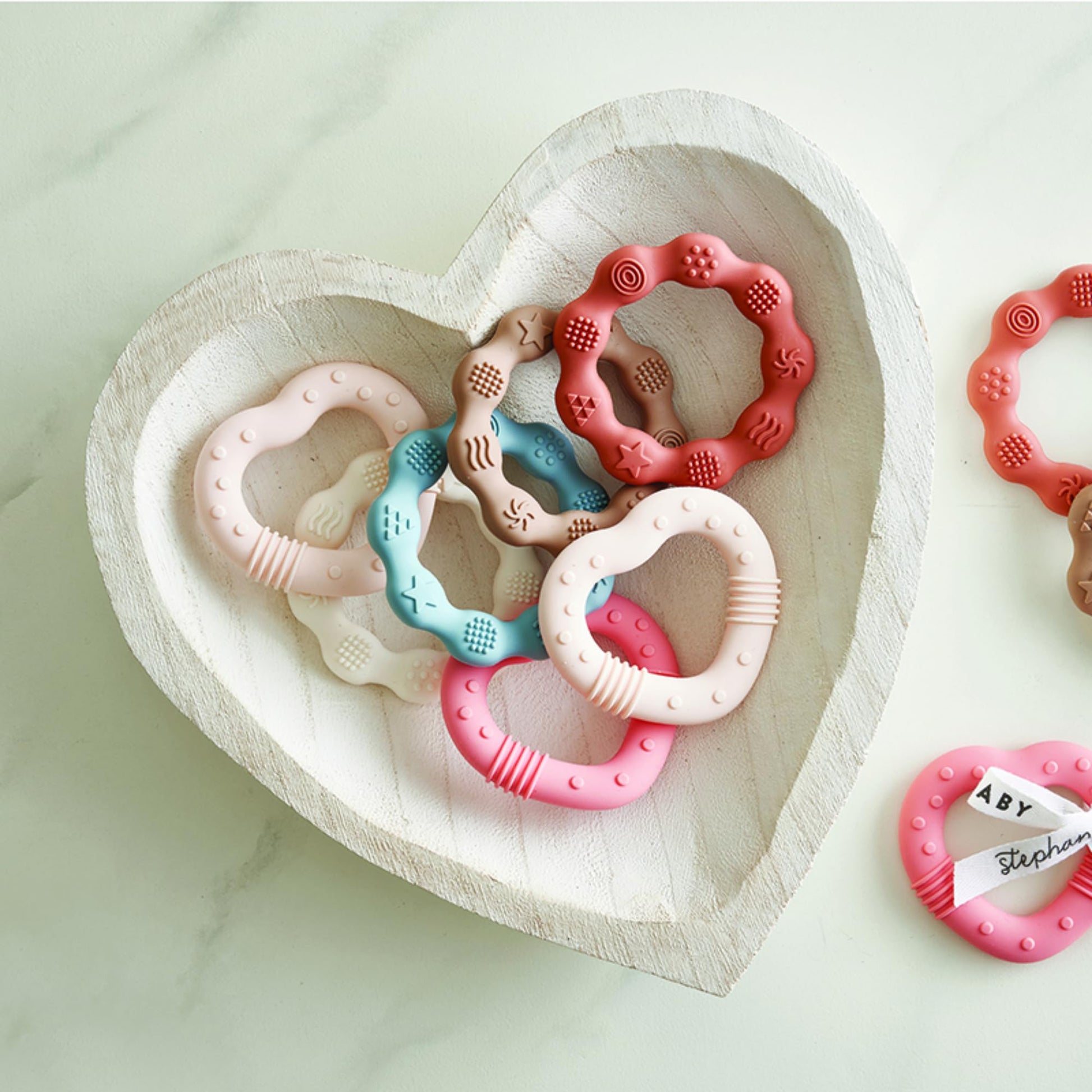 Stephan Baby Infant Teether - Heart-Shaped Silicone Baby Teething Toy with Integrated Texture, 3", Light Pink