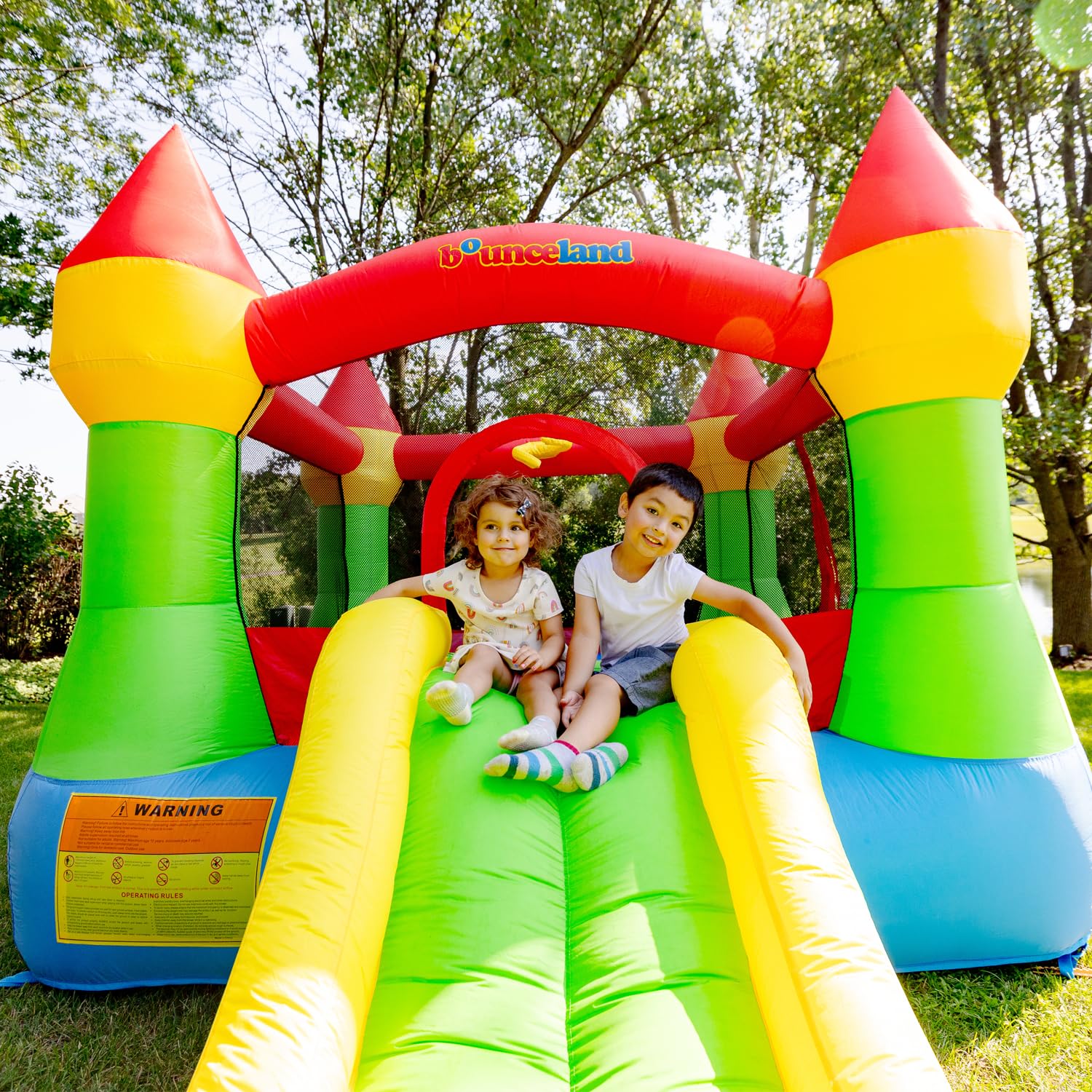 Bounceland Bounce House Castle with Basketball Hoop Inflatable Bouncer, Fun Slide, Safe Entrance Opening, UL Certified Strong Blower Included, 12 ft x