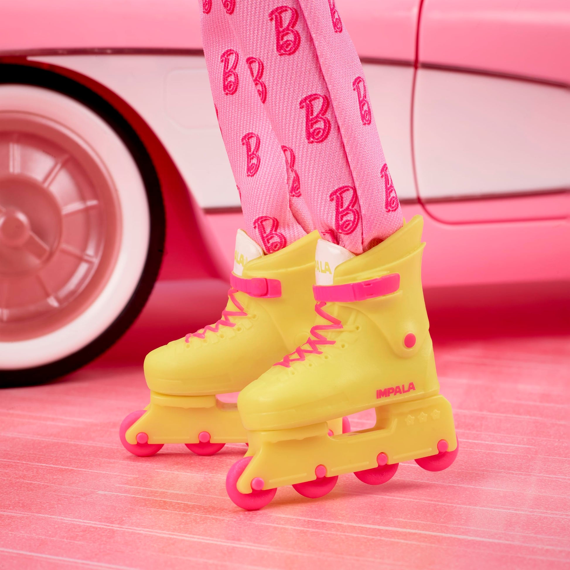 Barbie The Movie Ken Collectible Doll, Ryan Gosling as Ken Wearing Pink Jumpsuit with “B” Detail with White Sneakers and Multicolor Roller Skates