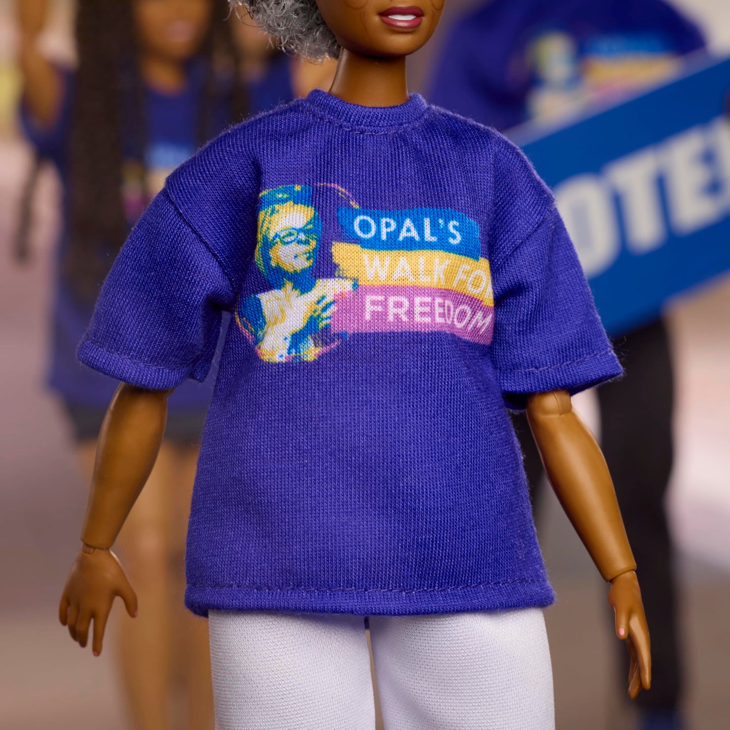Barbie Inspiring Women Doll, Opal Lee Collectible in Blue “Opal’s Walk for Freedom” T-Shirt, White Pants and Glasses, Doll Stand and Displayable