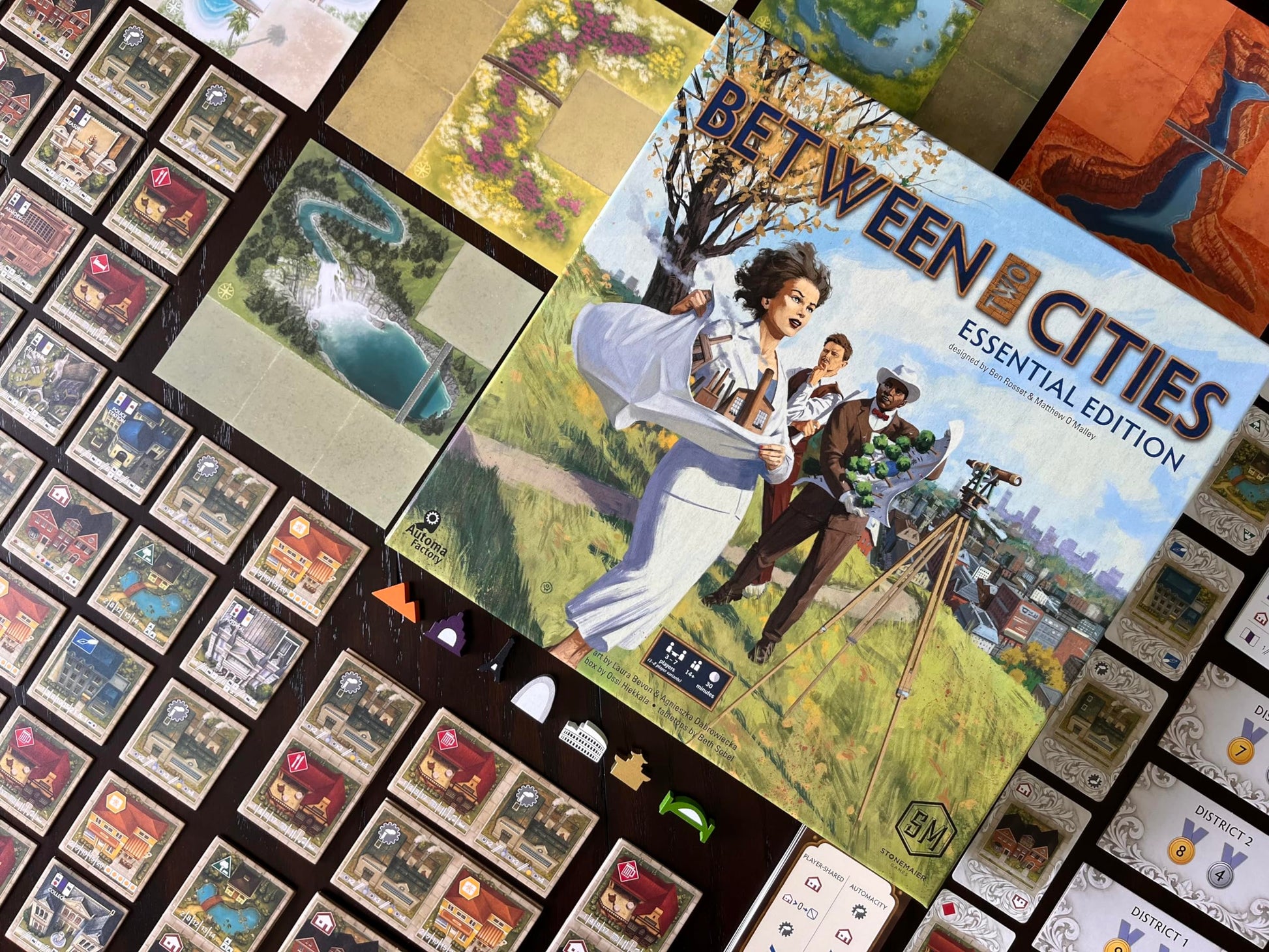 Stonemaier Games: Between Two Cities Essential Edition by Matthew O'Malley & Ben Rosset | Build Cities Cooperatively with Your Neighbors | Strategy
