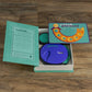 WS Game Company Catch Phrase Game Vintage Bookshelf Edition in Linen-Wrapped Book Case - Electronic Timer & 16 Double-Sided Disks Featuring 2,300+