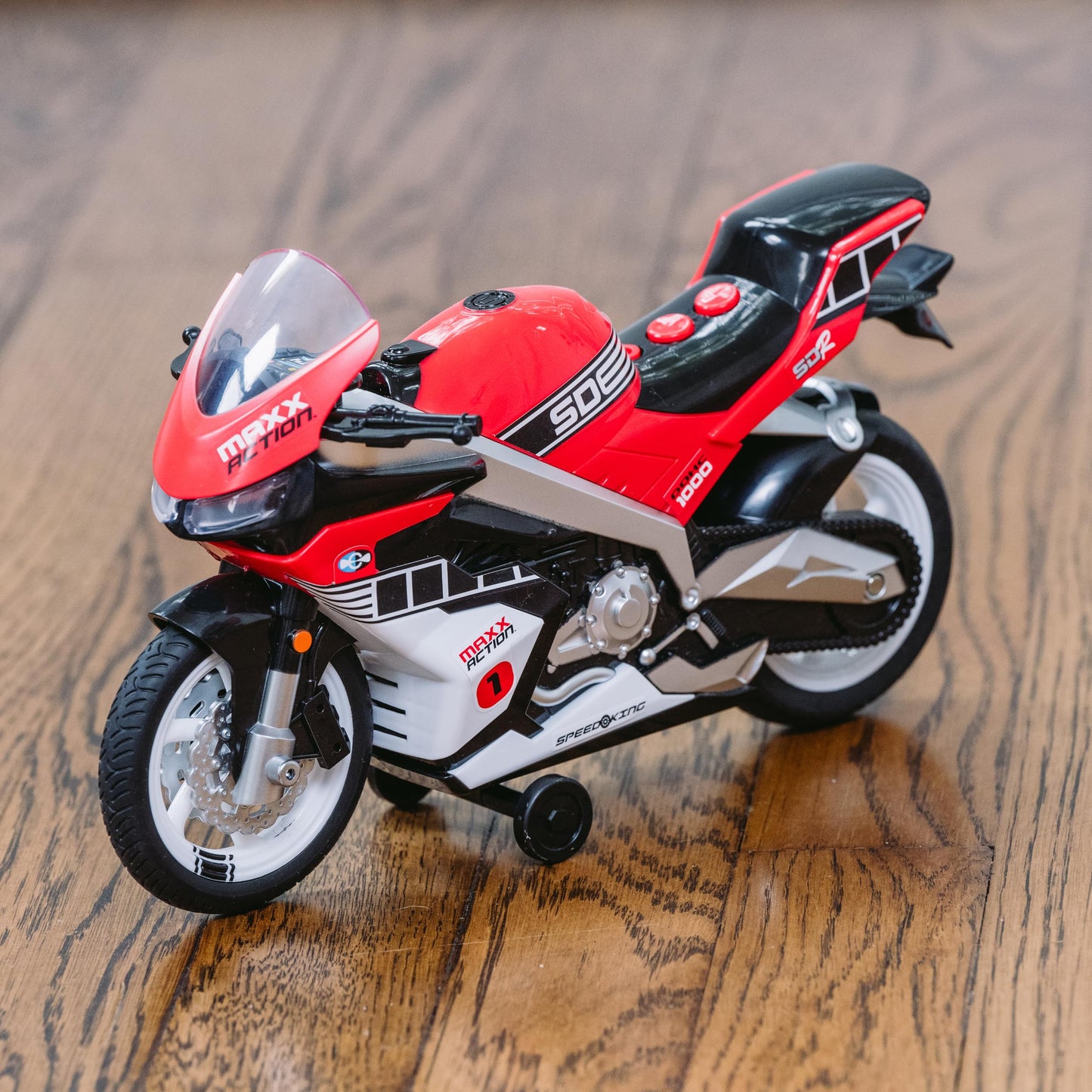 Sunny Days Entertainment Maxx Action Super Bike with Wheelie Feature - Red Motorized Toy Motorcycle for Boys & Girls | Light & Sound Vehicle for Kids